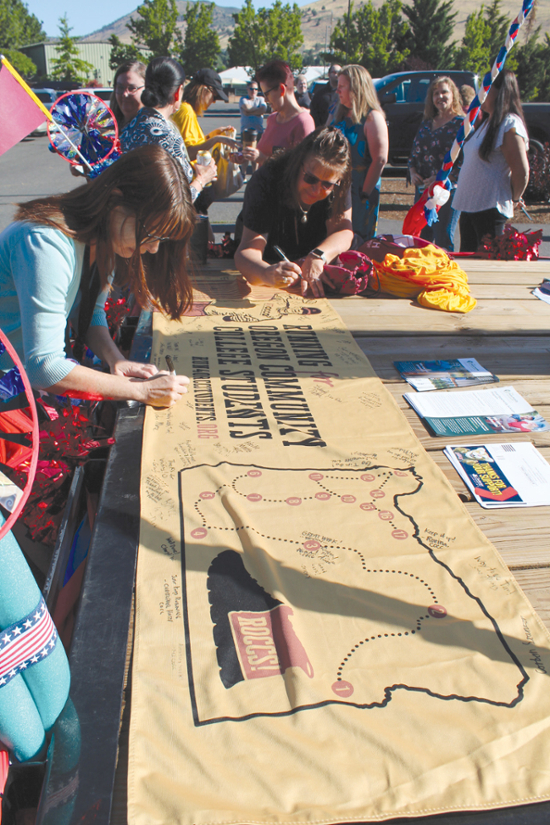 Klamath Community College staff sign the banner for Running for Community College Students or ROCCS! Campaign, Monday at  KCC.